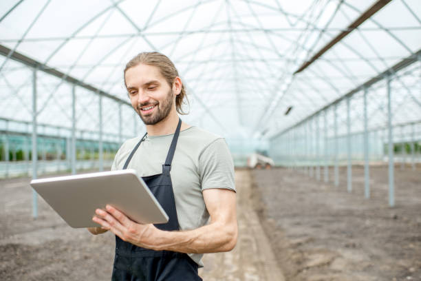 istock Farmer with tablet in the glasshouse 1002405934