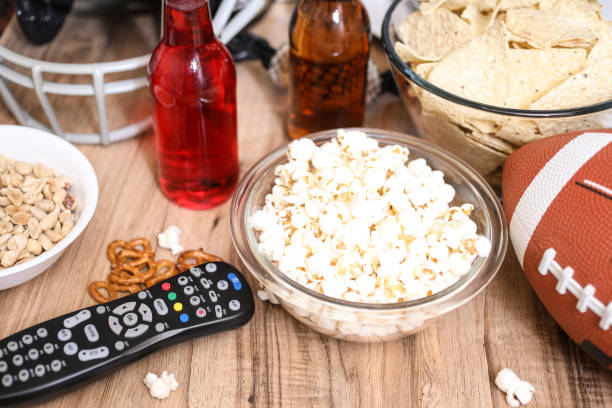 istock Watching the football game with snacks, drinks. 1002409080
