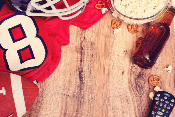 istock Watching the football game with snacks, drinks. 1002409278