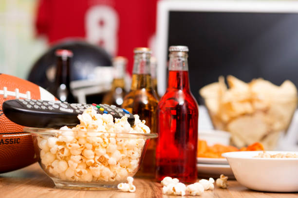 istock Watching the football game with snacks, drinks. 1002409406