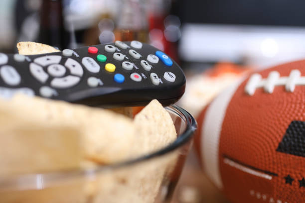 istock Watching the football game with snacks, drinks. 1002409422