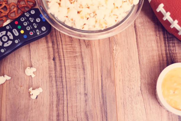 istock Watching the football game with snacks, drinks. 1002409446