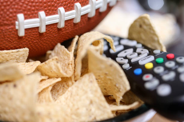 istock Watching the football game with snacks. 1002409528