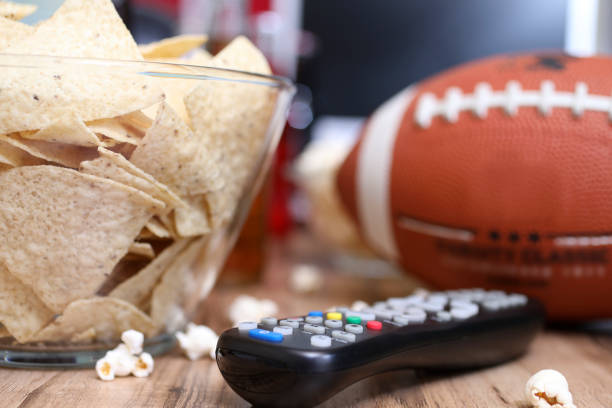 istock Watching the football game with snacks, drinks. 1002409560
