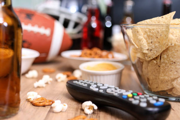 istock Watching the football game with snacks, drinks. 1002409642