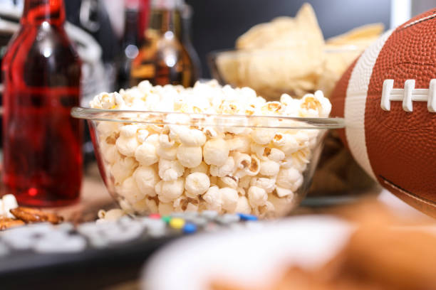 istock Watching the football game with snacks, drinks. 1002409726