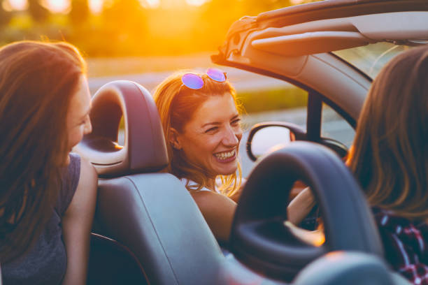 istock Friends on a road trip with cabriolet 1002418142