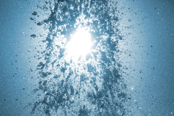 abstract water splashes from the fountain in the city public park against the sky