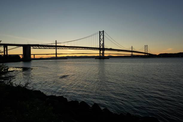istock Sunset behind the Forth Road Bridge and Queensferry Crossing 1002438398