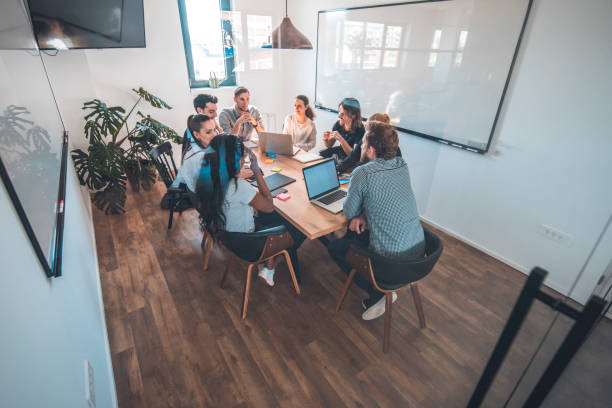 istock Colleagues discussing in board room during meeting 1002439726