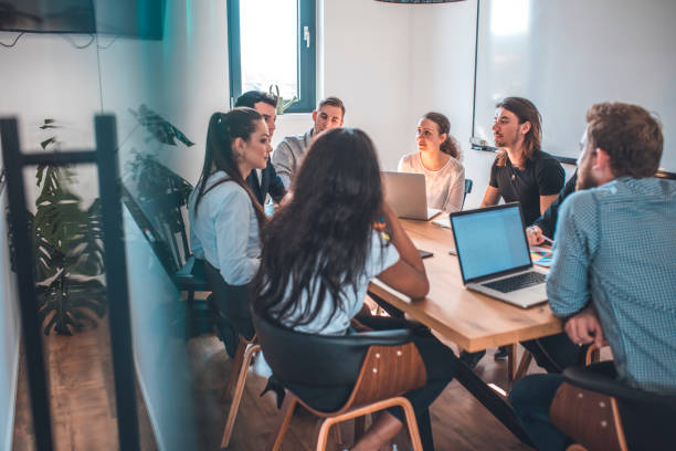 istock Colleagues discussing during meeting in office 1002439750