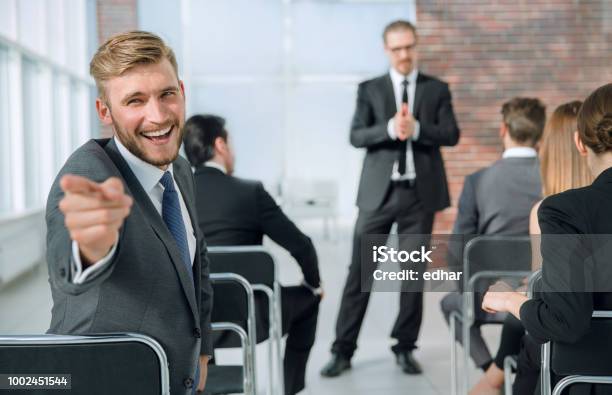 Young Man In Lecture Turning Back Stock Photo - Download Image Now - Founder, Adult, Assistant