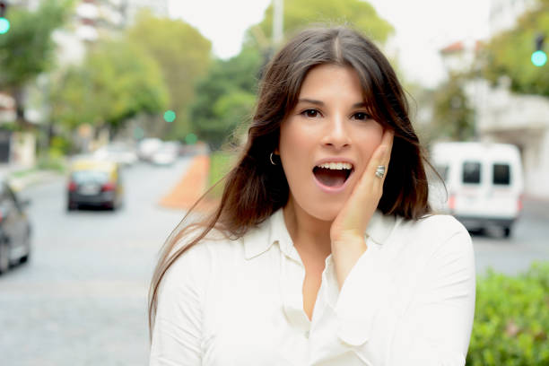 istock Young woman with surprised expression. Outdoor. 1002455638