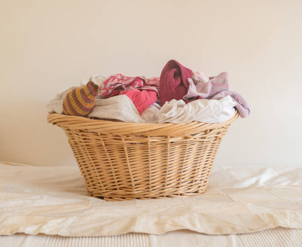 istock Wicker laundry basket wiht pink and white washing 1002455934