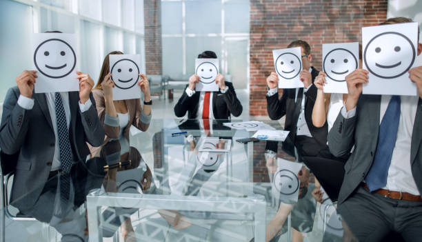 istock Business Team holding a paper with a positive smiley 1002456404