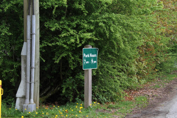 istock A green park hours sign on a post