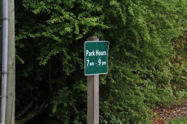 istock A green park hours sign on a post