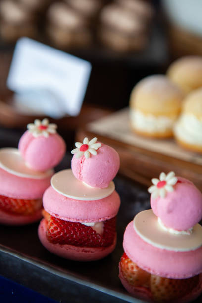 istock Colorful Double Macarons filled with Fresh Summer Strawberry and cream. 1002466394