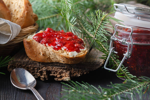 istock Cup of tea with berry jam on old wooden table 1002485504