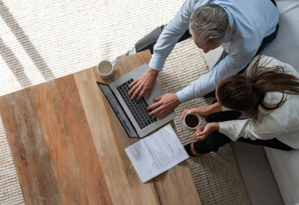 istock Loving couple paying bills online at home 1002488670