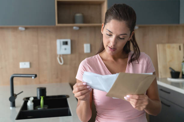 istock Woman at home checking her mail 1002488800