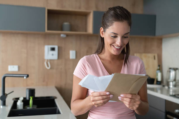 istock Woman at home checking her mail 1002488854