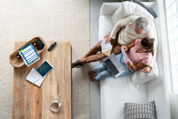 istock Loving couple paying bills online at home 1002488912