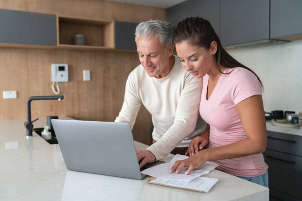 istock Loving couple paying bills online at home 1002488922