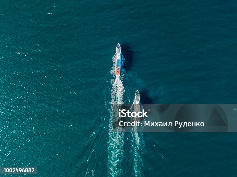 istock top view of two cruise ships in the open sea, one outrunning another 1002496882