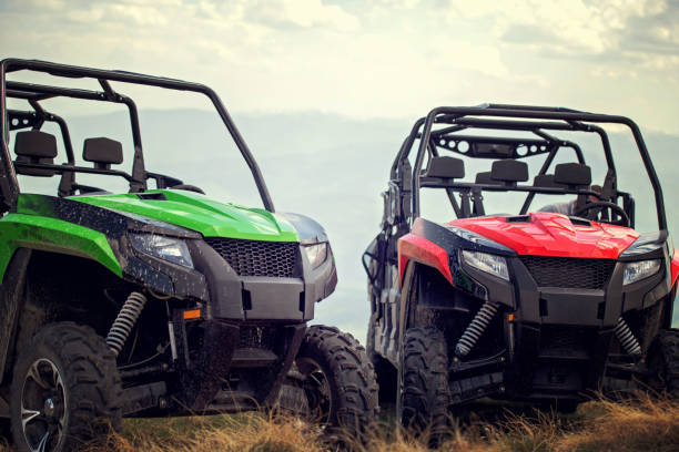 Friends driving off-road with quad bike or ATV and UTV vehicles Friends driving off-road with quad bike or ATV and UTV vehicles. off road vehicle photos stock pictures, royalty-free photos & images