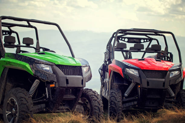 friends driving off-road with quad bike or atv and utv vehicles - off road vehicle fotos imagens e fotografias de stock