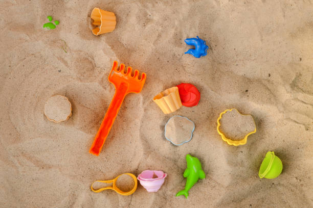 istock High Angle View Of Various Toys On Sand 1002508894