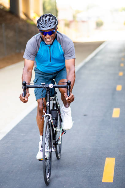 istock Senior Black Man Riding Bike on Trail 1002513998