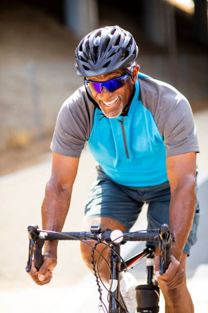 istock Senior Black Man Racing on a Road Bike 1002514404