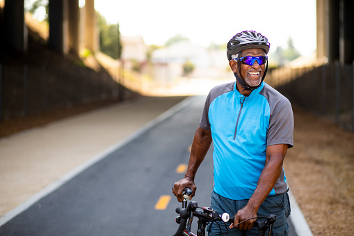 Portrait of a senior black man with his bicycle.