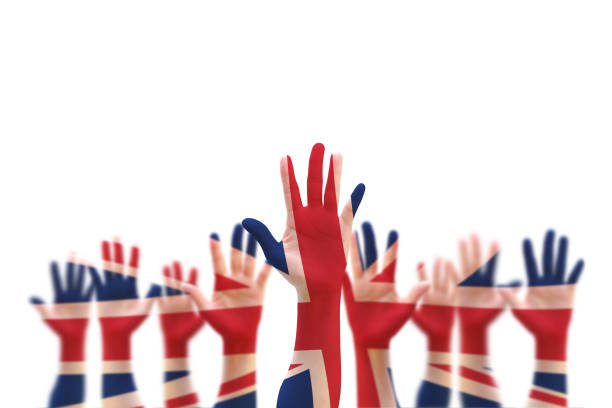 istock United kingdom (UK) flag pattern on people participation hands in democratic voting (isolated with clipping path) 1002517914