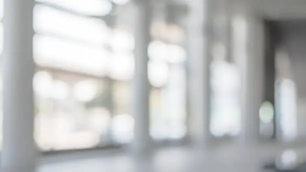 Photo of Blur background interior view looking out toward to empty office lobby and entrance doors and glass curtain wall