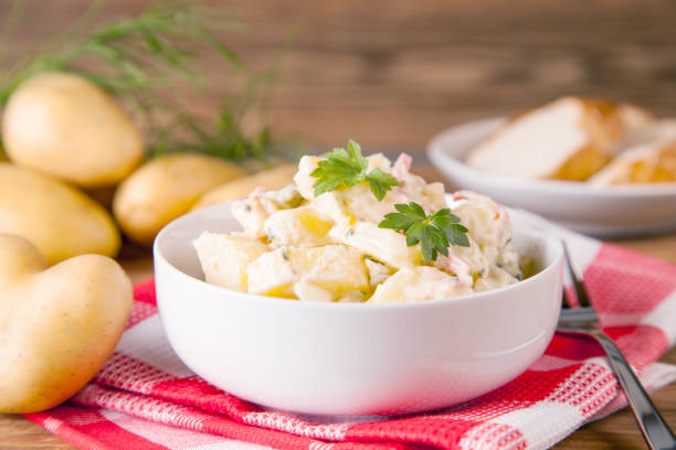 istock Potato salad on an old rustic wooden table (german food) 1002519414