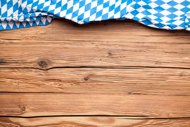 istock Beer Fest tablecloth on an old rustic wooden background 1002519756
