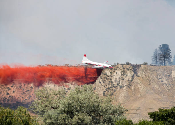 Firefighting An aerial assault on a difficult mountain fire. Taken in Kamloops, British Columbia military tanker airplane photos stock pictures, royalty-free photos & images