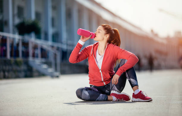 istock Woman drinking water after workout 1002523458