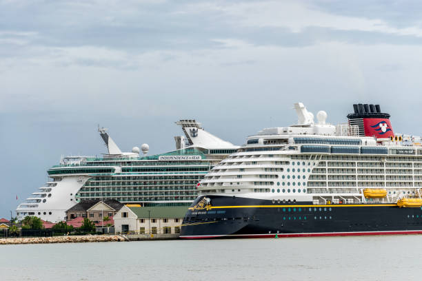 Disney Fantasy and Royal Caribbean Independence of the Seas Cruise Ships Falmouth, Jamaica - June 03 2015: Disney Fantasy and Royal Caribbean Independence of the Seas cruise ships docked side by side at the Falmouth Cruise Port in Jamaica. falmouth harbor stock pictures, royalty-free photos & images