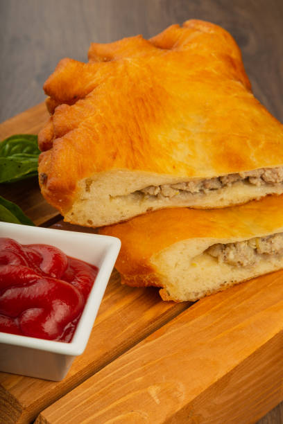istock Chebureks made at home, crispy crust, wood background 1002529458