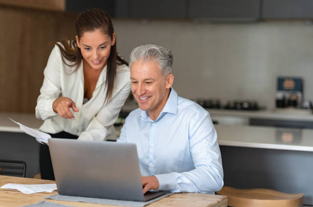 istock Happy couple paying bills online at home 1002529884