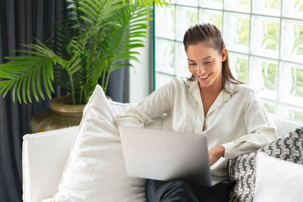 istock Business woman at home working online on a laptop computer 1002529924