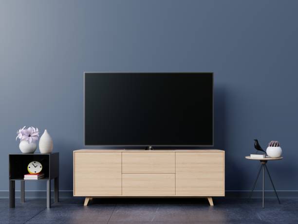 istock TV in live room and dark wall 1002544610