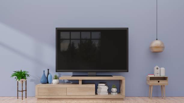 istock Smart TV on cabinet and dark wall background 1002544616