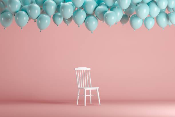 istock White chair with floating blue balloons in pink background room studio. minimal idea creative concept. 1002544718