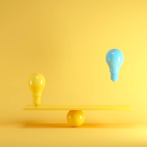 istock Outstanding Blue light bulb floating between yellow lightbulb on yellow seesaw, minimal idea concept. 1002544958