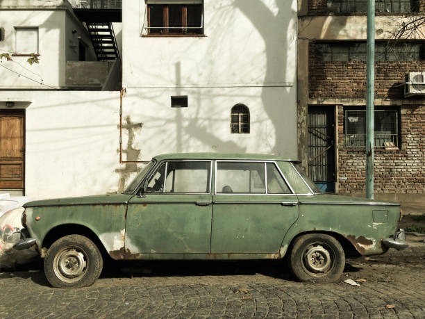 istock Old rusty car parked in the street 1002547462